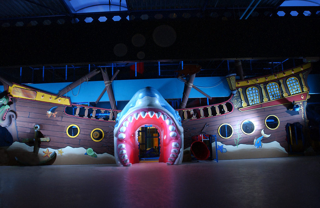 A large pirate ship featuring a shark mouth design