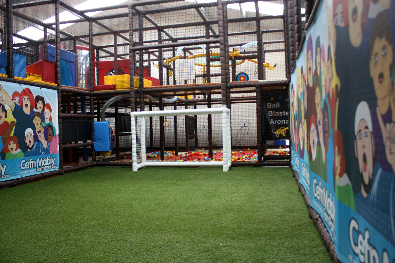 A spacious indoor play area featuring a football goal