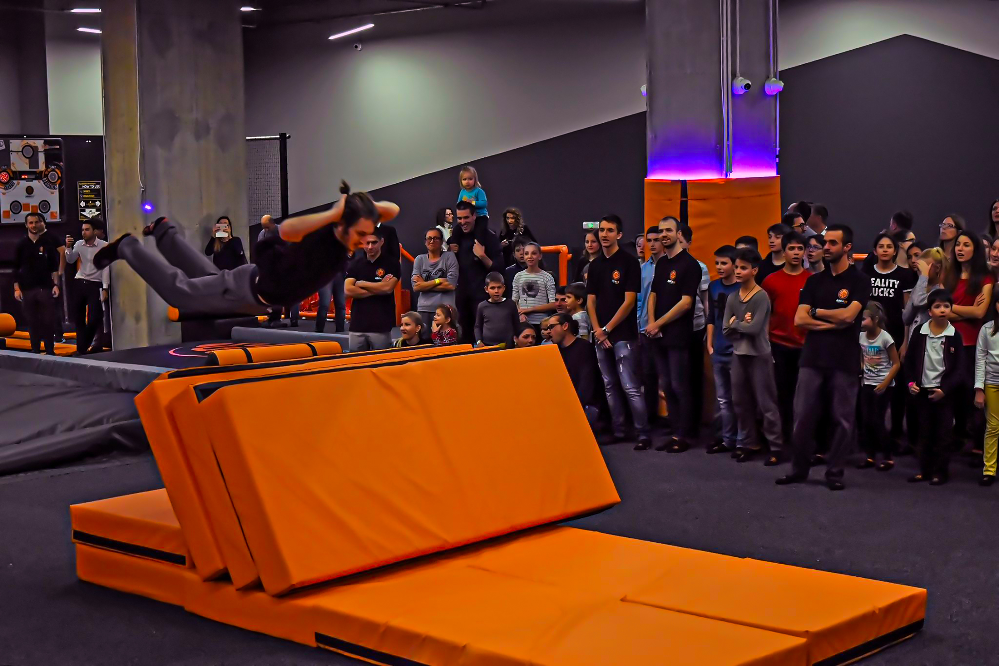 A man showing a trick on a mat.